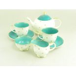 A SUSIE COOPER TEA SET FOR TWO, TEAPOT CRACKED