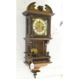 A GERMAN WALNUT AND STAINED SOFTWOOD WALL CLOCK WITH PRIMROSE ENAMEL CHAPTER RING