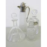 AN EPNS MOUNTED CUT GLASS CLARET JUG AND THREE GLASS DECANTERS AND STOPPERS