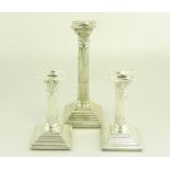 ONE AND A PAIR OF SILVER CORINTHIAN COLUMN CANDLESTICKS, BIRMINGHAM AND SHEFFIELD, 1912 AND 1954,