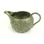 A VICTORIAN SILVER CREAM JUG IN INDIAN STYLE, LONDON 1880 , 2OZS