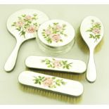 AN ELIZABETH II SILVER AND GUILLOCHE ENAMEL FIVE PIECE BRUSH SET, THE BACKS PAINTED WITH ROSES,