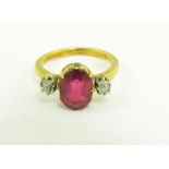 A SYNTHETIC RUBY AND DIAMOND THREE STONE RING IN GOLD, 3.4G