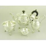 AN EDWARD VII/GEORGE V SILVER THREE PIECE TEA SERVICE ON SHELL FEET, LONDON 1908, 1912 AND 1913