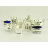 A GEORGE V SILVER PIERCED THREE PIECE CONDIMENT SET, BLUE GLASS LINERS, BIRMINGHAM 1918 AND SEVEN