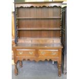 AN OAK DRESSER, THE RACK WITH ROW OF SPICE DRAWERS