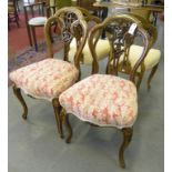 A SET OF FOUR VICTORIAN WALNUT DINING CHAIRS WITH CARVED AND FOLIATE PIERCED SPLAT