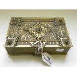 AN ORNATE LATE 19TH CENTURY CAST BRASS JEWEL CASKET IN THE FORM OF AN ELABORATELY BOUND BOOK,