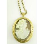 A CAMEO BROOCH - PENDANT, THE OVAL SHELL CARVED WITH THE HEAD OF A LADY IN GOLD MOUNT, ON A GOLD