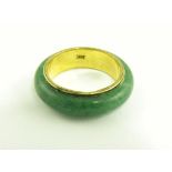 A SOUTH EAST ASIAN JADE RING WITH GOLD CORE, MARKED 14K, 3.6G