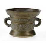 A DUTCH BRONZE MORTAR, DATED 1607 cast with two bands, one of foliage and birds, zoomorphic handles,