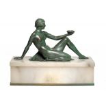 AN ART DECO GREEN AND BRONZE PATINATED METAL FIGURAL LAMP AS A YOUNG WOMAN ON ILLUMINATED ONYX