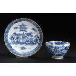 A CAUGHLEY BLUE AND WHITE SHANKED TEA BOWL AND SAUCER, C1790 painted with the Tower pattern,