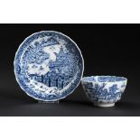 A CAUGHLEY BLUE AND WHITE SHANKED TEA BOWL AND SAUCER, C1790 printed with the Striped Temple