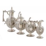 A VICTORIAN SILVER TEA AND COFFEE SERVICE chased in high relief with fruit and flowers, coffee pot