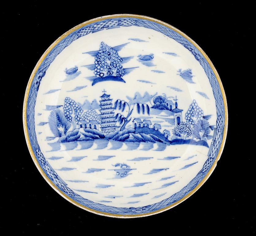 A CAUGHLEY BLUE AND WHITE SAUCER DISH, C1790 freely painted with the Tower pattern, 22cm diam ++