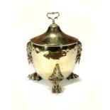 A BRASS VASE SHAPED COAL BOX AND COVER, EARLY 20TH C with cast grotesque mask handles and paw