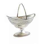 A GEORGE III PIERCED SILVER NAVETTE SHAPED SUGAR BASKET with swing handle, crested, 18cm h, by