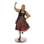 A SCOTTISH CLOTHIER AND HABERDASHER'S SHOP WINDOW FIGURE OF A GIRL, C1920 of carved wood, dancing