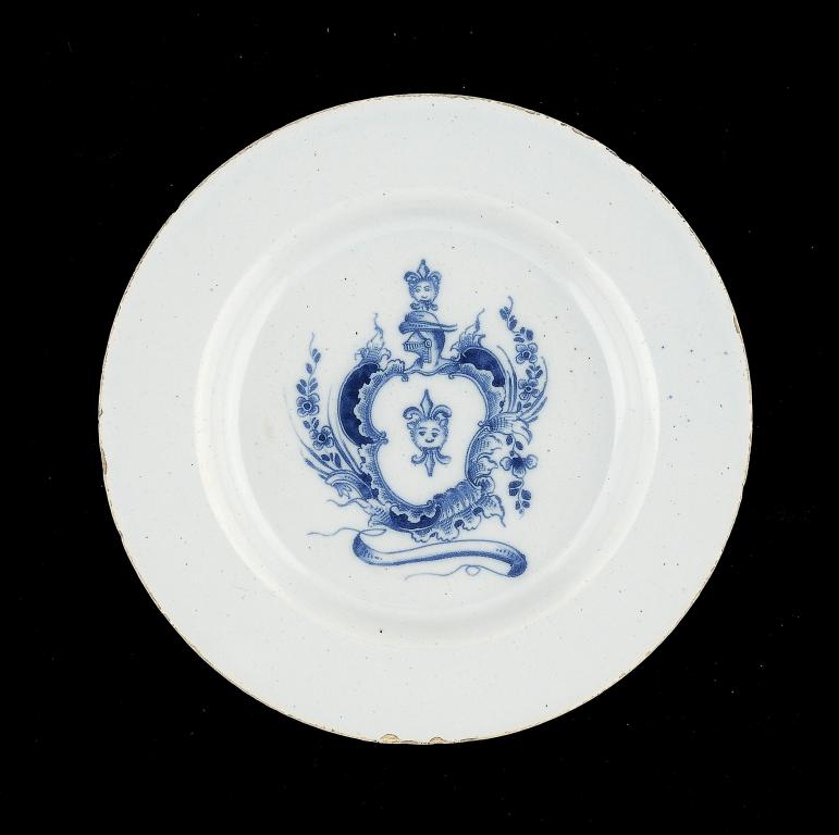 A RARE ENGLISH DELFTWARE ARMORIAL PLATE, C1750-60 23cm diam The arms and crest are those of