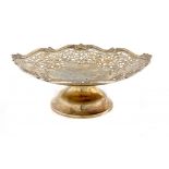 A GEORGE V SILVER FRUIT STAND saw pierced with a wide border of scrolling foliage, 28.5cm over