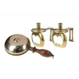 AN UNUSUAL PAIR OF VICTORIAN BRASS ANGLED CANDLESTICKS AND A VICTORIAN BRASS MAMIFORM HANDBELL