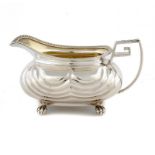 A GEORGE III SILVER FLUTED OBLONG CREAM JUG 7.5cm h, by James Turner, London 1806, 7ozs 10dwts ++A