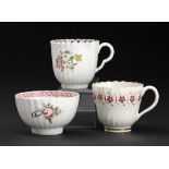 A CAUGHLEY POLYCHROME TEA BOWL AND TWO COFFEE CUPS, C1792-95 in the Pink Rim and Roses, Dahlia and