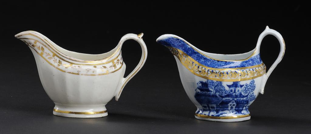 A CALCUT WHITE AND GILT FLUTED CREAM BOAT AND A JOHN ROSE BLUE AND WHITE CREAM BOAT, C1794-96 AND
