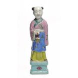 A CHINESE FAMILLE ROSE FIGURE OF A SMILING BOY HOLDING A BASKET, 19TH OR 20TH C 21cm h ++Small