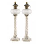 A PAIR OF VICTORIAN SILVER COLUMNAR OIL LAMPS with cut glass fount and plated burner, 64cm h, by