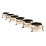 A SET OF SIX VICTORIAN CHASED SILVER SALT CELLARS 6.5cm diam, by Robert Harper, London 1866,