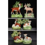 A PAIR OF STAFFORDSHIRE EARTHENWARE MODELS OF DEER AT LODGE AND FOUR MODELS OF DEER AND SHEEP,