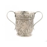 A GEORGE II SILVER PORRINGER foliate chased, with vacant cartouche, 8.5cm h, by John Elston,