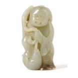 A CHINESE JADE PEBBLE CARVING OF A SMILING BOY WITH A HOOKED FISH, 19TH/20TH C 6cm h ++In good