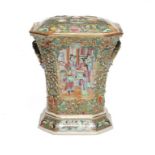 A CANTON FAMILLE ROSE RELIEF MOULDED AND FLARED OCTAGONAL BOUGH POT AND COVER, MID 19TH C the