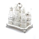 A WILLIAM IV SILVER CRUET retaining the seven cut glass condiment bottles, three silver mounted,