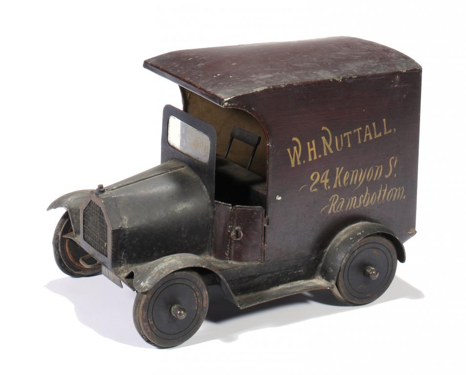 A TINPLATE SHOPKEEPER'S MODEL DELIVERY VAN, C1920 the body painted in reddish brown to resemble wood