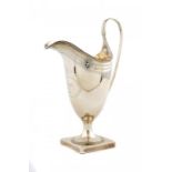 A GEORGE III SILVER ENGRAVED HELMET SHAPED CREAM JUG crested, 16cm h, by Hester Batemen, London