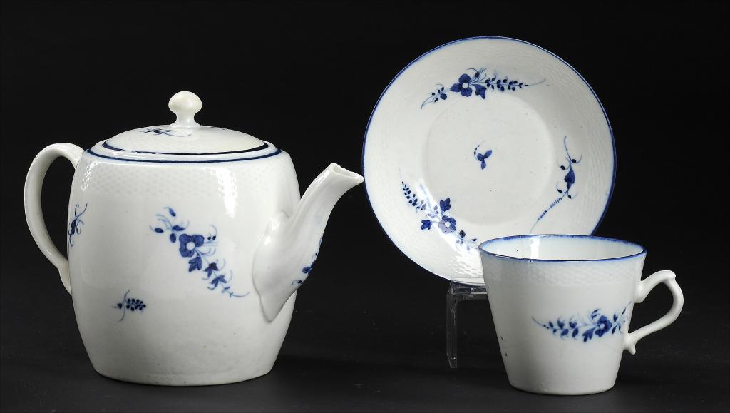 A CAUGHLEY BLUE AND WHITE BARREL SHAPED TEAPOT AND COVER AND A MATCHING CAUGHLEY CUP AND SAUCER,