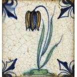 A DUTCH DELFTWARE POLYCHROME TILE, 18TH C painted with a tulip and fleur de lys, 11.5cm square,