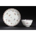 A CAUGHLEY POLYCHROME SHANKED TEA BOWL AND SAUCER, C1792-95 enamelled with the Rose Swags pattern,