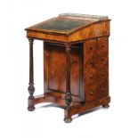 A VICTORIAN WALNUT AND EBONISED DAVENPORT, C1870 with brass gallery and figured ash veneered