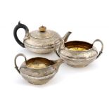 A GEORGE IV SILVER TEA SERVICE with integral hinge to teapot, crested, teapot 12cm h, by R, J & S