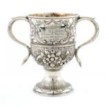 A GEORGE III SILVER CUP later chased, on spume foot, 15cm h, maker WC, a pellet between, probably