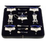 AN EDWARD VII ART NOUVEAU SILVER SEVEN PIECE COMPOSED CONDIMENT SET with Albany pattern spoons and