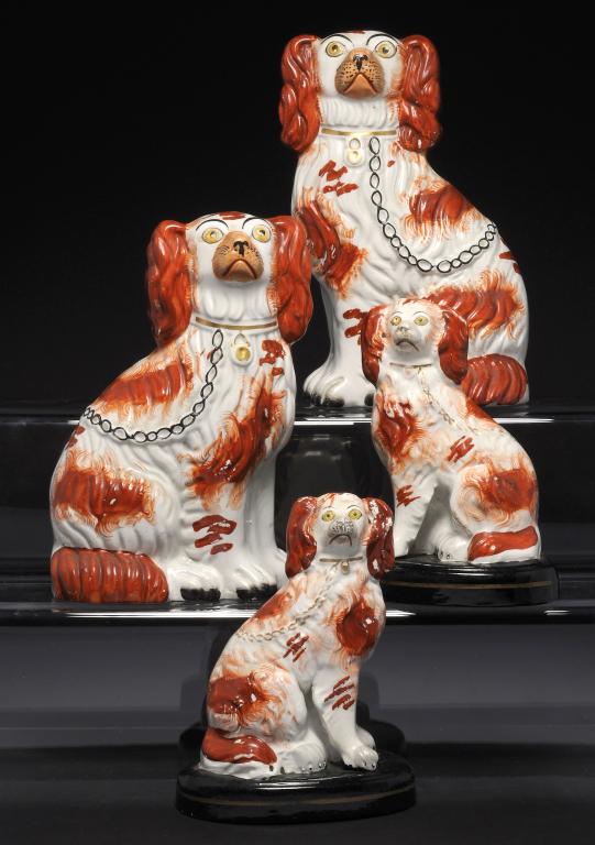 TWO PAIRS OF STAFFORDSHIRE EARTHENWARE MODELS OF SPANIELS, C1880 black faced pair 17cm h ++One of