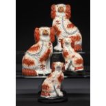 TWO PAIRS OF STAFFORDSHIRE EARTHENWARE MODELS OF SPANIELS, C1880 black faced pair 17cm h ++One of