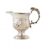 A GEORGE II SILVER REPOUSSÉ CREAM JUG with hound handle, crested, 10cm h, maker's mark illegible,