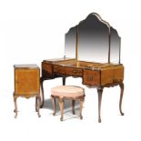 A FIGURED WALNUT SERPENTINE BEDROOM SUITE, C1930 quarter veneered and crossbanded, comprising